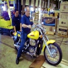 experienced motorcycle rider loading motorcycle onto pallet